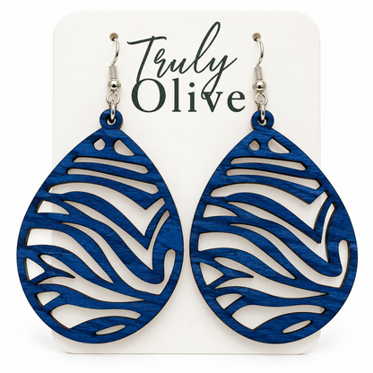 Marine Blue wood teardrop earrings with visible grain, zebra cutouts, and silver-tone hooks on a white Truly Olive card.