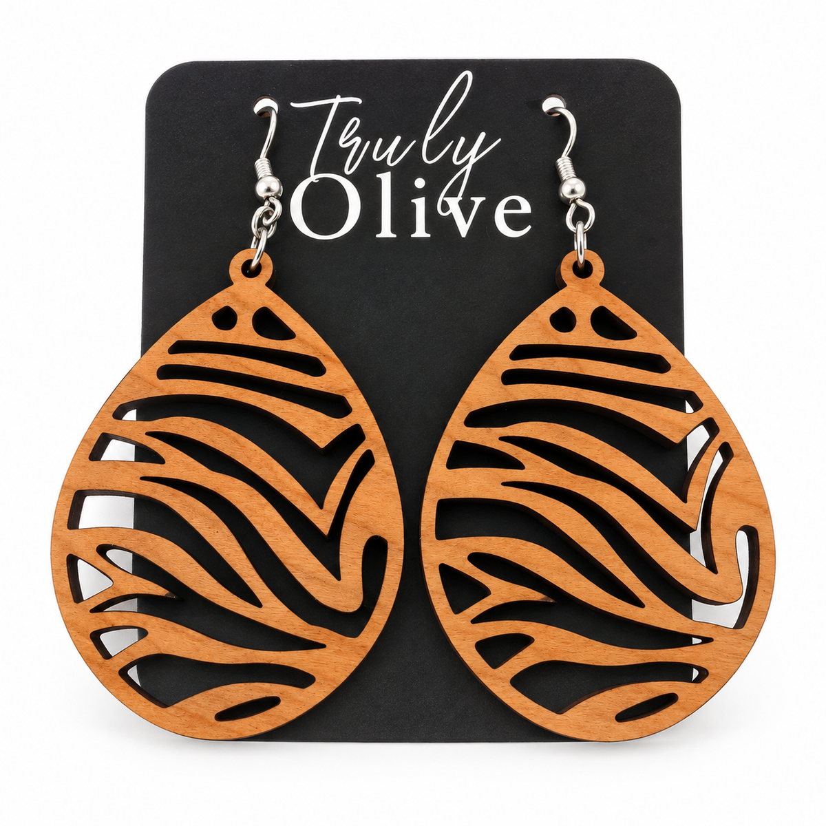 Caramel-toned Cherry wood teardrop earrings with sweeping zebra cutouts on a black Truly Olive card against white.