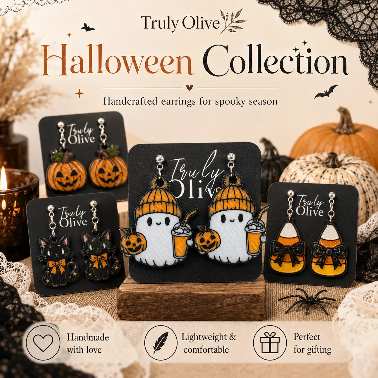 Overhead Halloween flat lay of cozy ghost earrings surrounded by orange pumpkins, black lace, spiderwebs, a decorative skull, and warm seasonal lights.