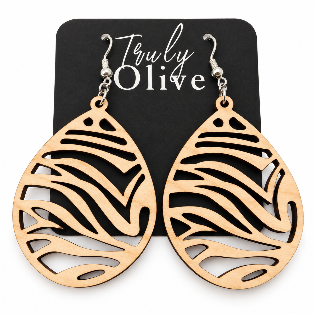 Pale Maple wood teardrop earrings with zebra-inspired cutouts and silver-tone hooks on a black Truly Olive card against white.
