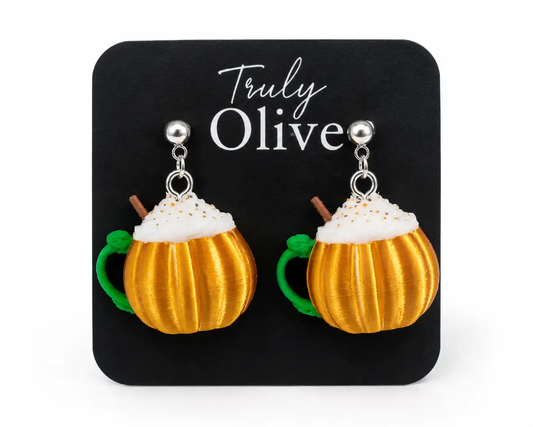 Handcrafted pumpkin spice mug earrings by Truly Olive featuring a pumpkin-shaped coffee cup with whipped cream and cinnamon stick, lightweight fall statement earrings on a white background.