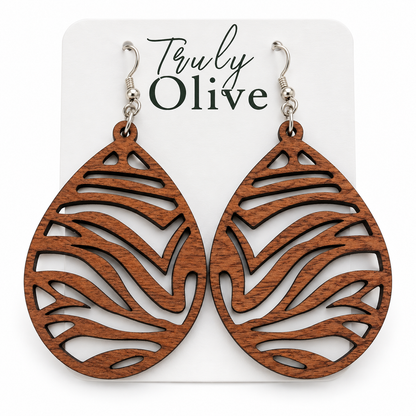 Warm brown Sapele wood teardrop earrings with zebra cutouts and silver-tone hooks on a white Truly Olive card.