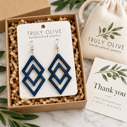 Marine Blue Connected Diamond wood earrings on a white Truly Olive card in a kraft box beside a branded pouch and thank-you note.