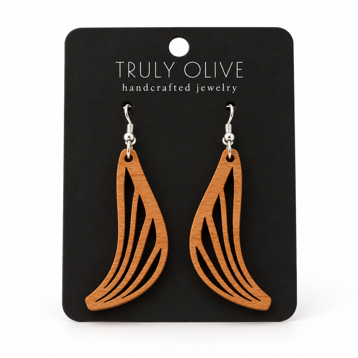 Swept Wing wood earrings in Cherry stain on a black Truly Olive card.