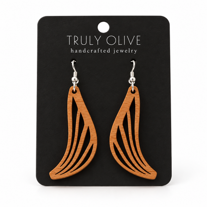 Swept Wing wood earrings in Cherry stain on a black Truly Olive card.