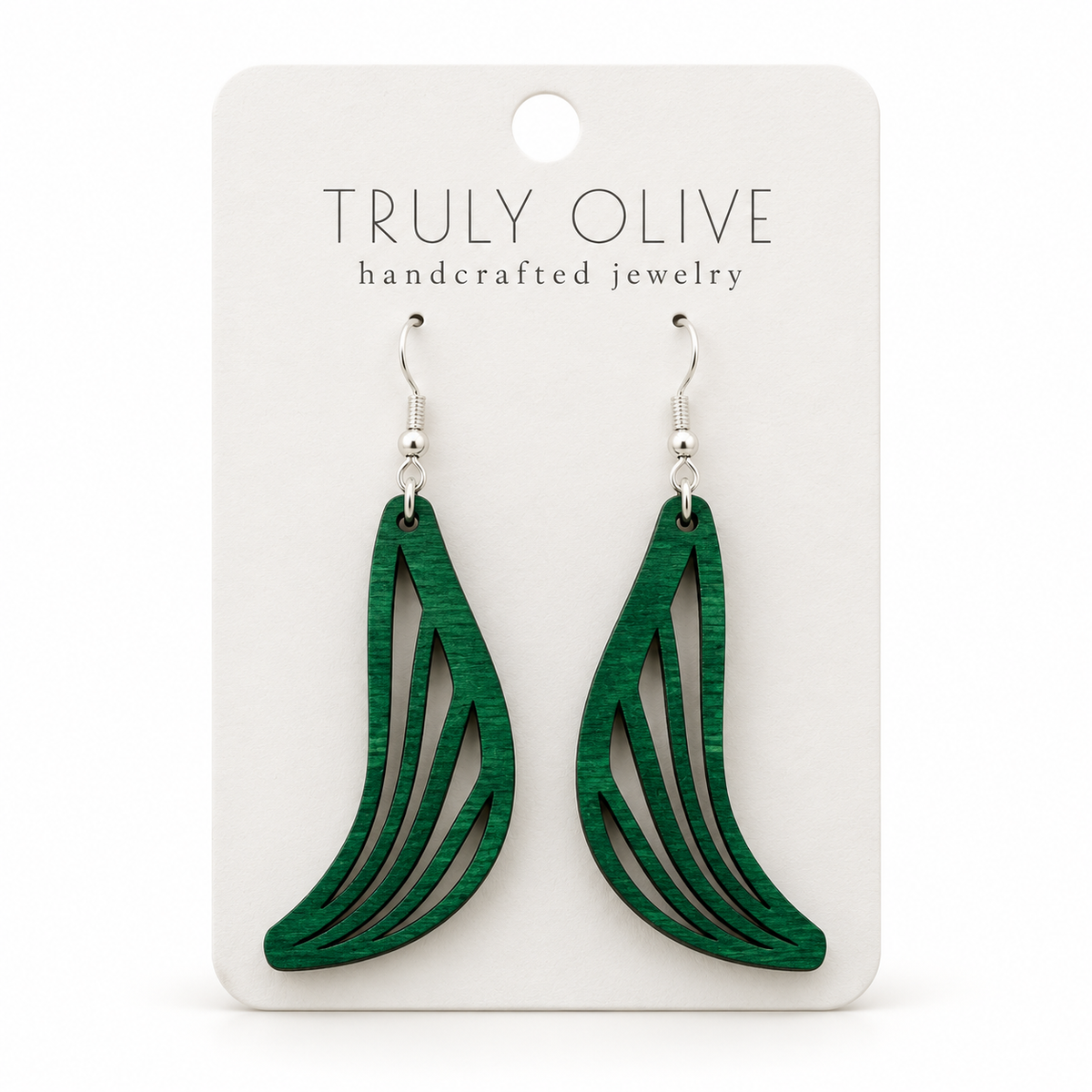 Swept Wing wood earrings in Green stain on a white Truly Olive card.