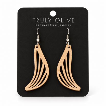Swept Wing wood earrings in Maple stain on a black Truly Olive card.