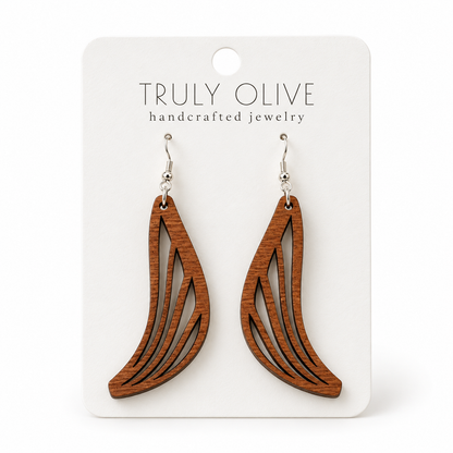 Swept Wing wood earrings in Sapele stain on a white Truly Olive card.