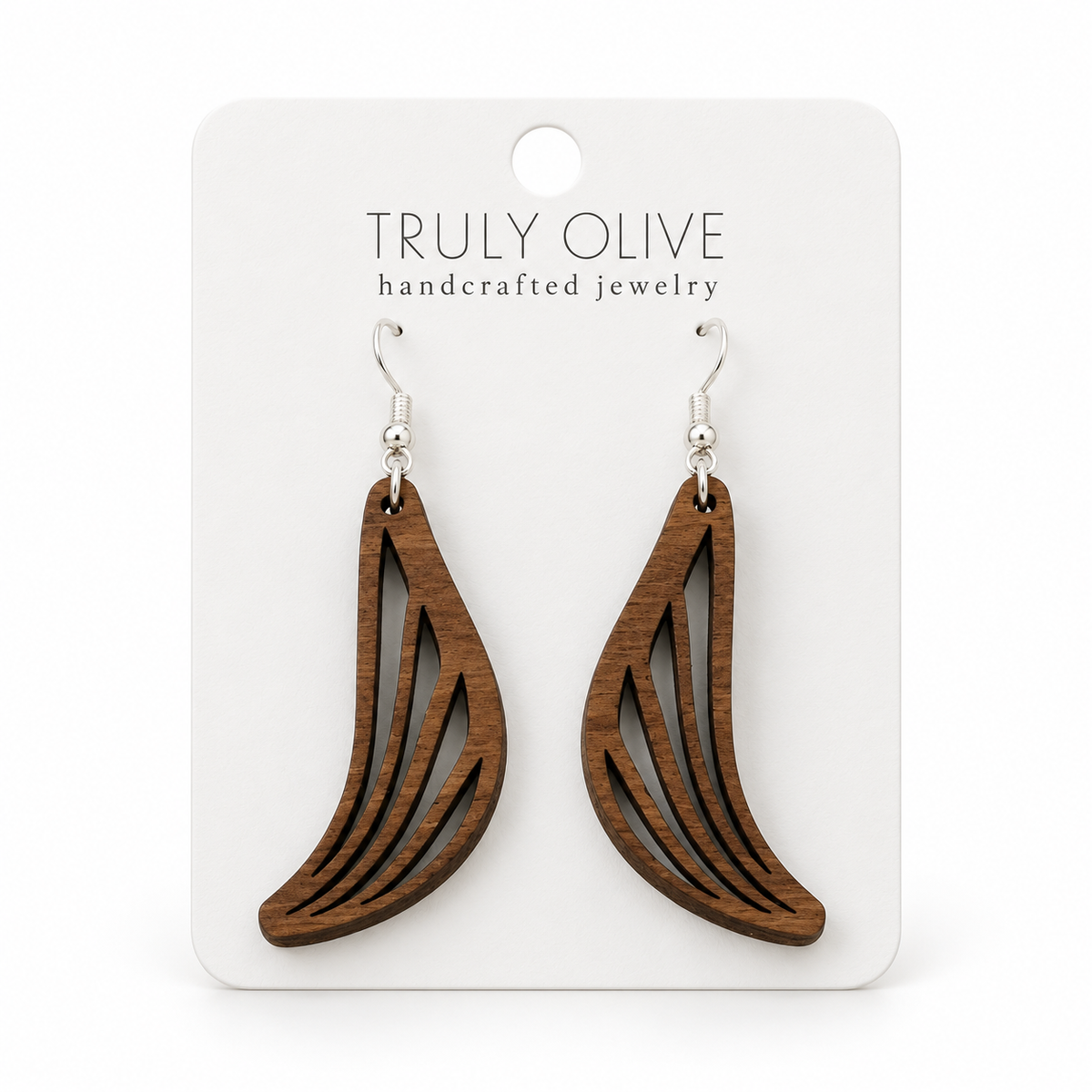 Swept Wing wood earrings in Walnut stain on a white Truly Olive card.