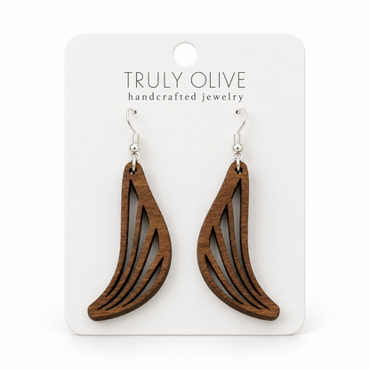 Swept Wing wood earrings in Walnut stain on a white Truly Olive card.