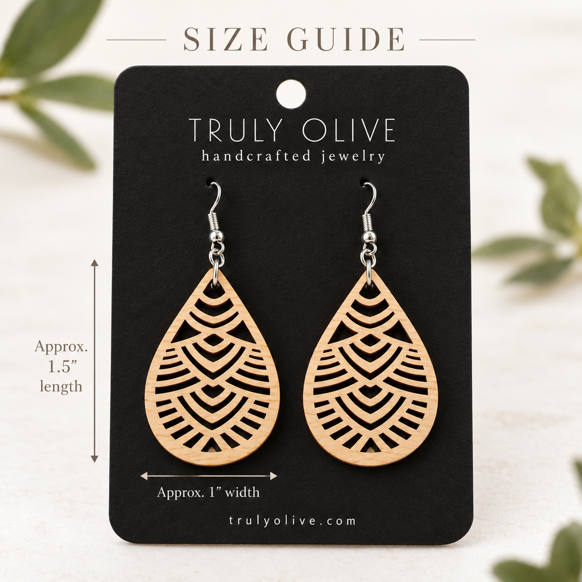 Maple Geometric Teardrop wood earrings on a black Truly Olive card with approximate measurements of 1.5 inches long and 1 inch wide.