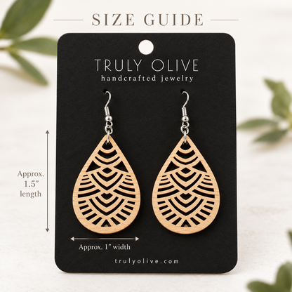 Maple Geometric Teardrop wood earrings on a black Truly Olive card with approximate measurements of 1.5 inches long and 1 inch wide.