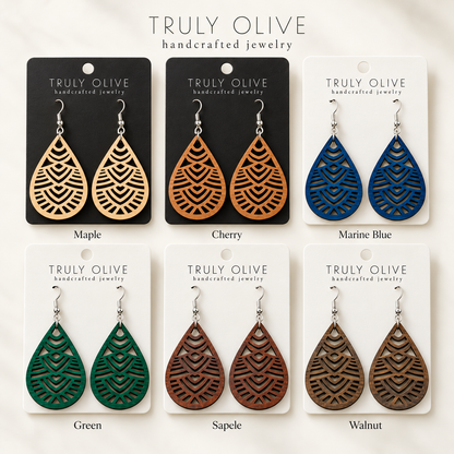 Geometric Teardrop wood earrings shown in Maple, Cherry, Marine Blue, Green, Sapele, and Walnut stains on Truly Olive cards.