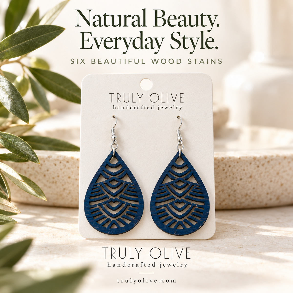 Marine Blue Geometric Teardrop wood earrings in a styled product image with Truly Olive branding.