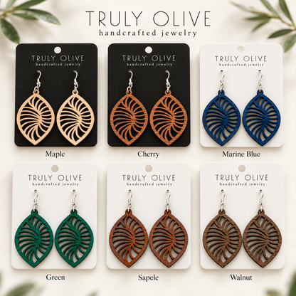 Spiral Leaf wood earrings shown in Maple, Cherry, Marine Blue, Green, Sapele, and Walnut stains on Truly Olive cards.