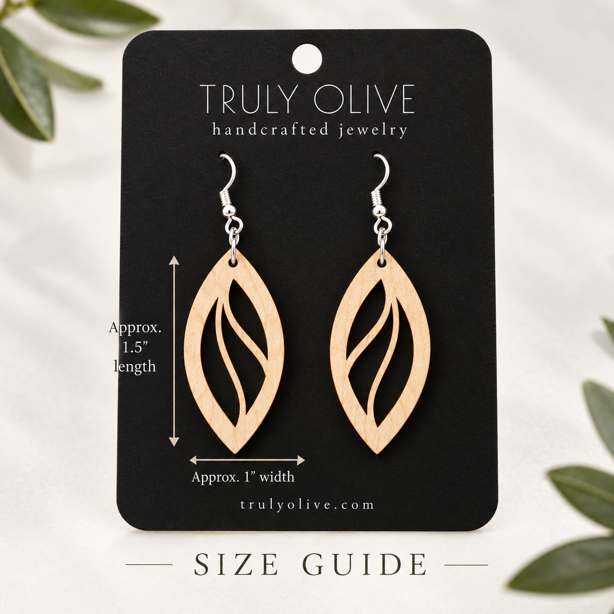Maple Open Leaf wood earrings on a black Truly Olive card with approximate measurements of 1.5 inches long and 1 inch wide.