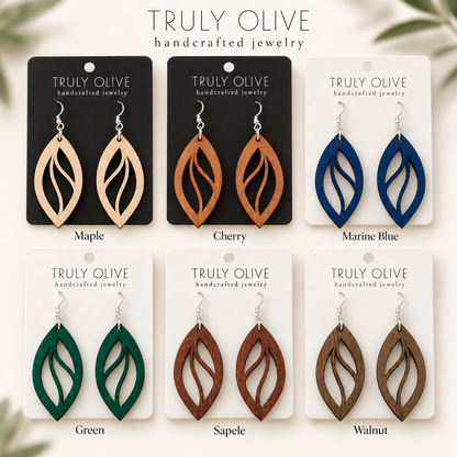 Open Leaf wood earrings shown in Maple, Cherry, Marine Blue, Green, Sapele, and Walnut stains on Truly Olive cards.