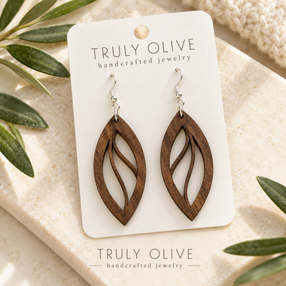 Walnut Open Leaf wood earrings arranged flat with Truly Olive branding.