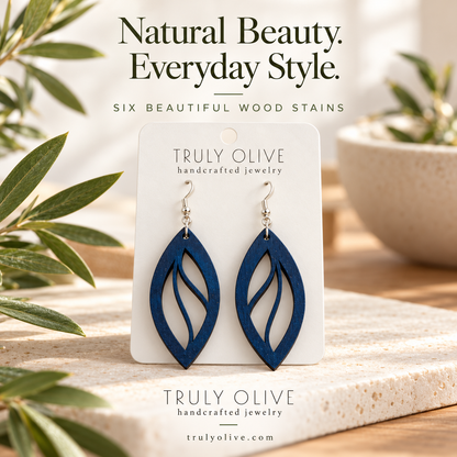 Marine Blue Open Leaf wood earrings in a styled product image with Truly Olive branding.