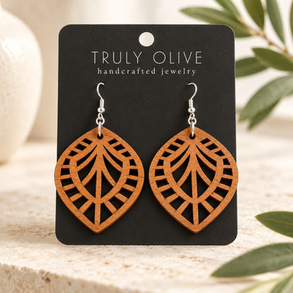 Leaf Lattice wood earrings in Cherry stain on a black Truly Olive card in a softly lit styled setting.