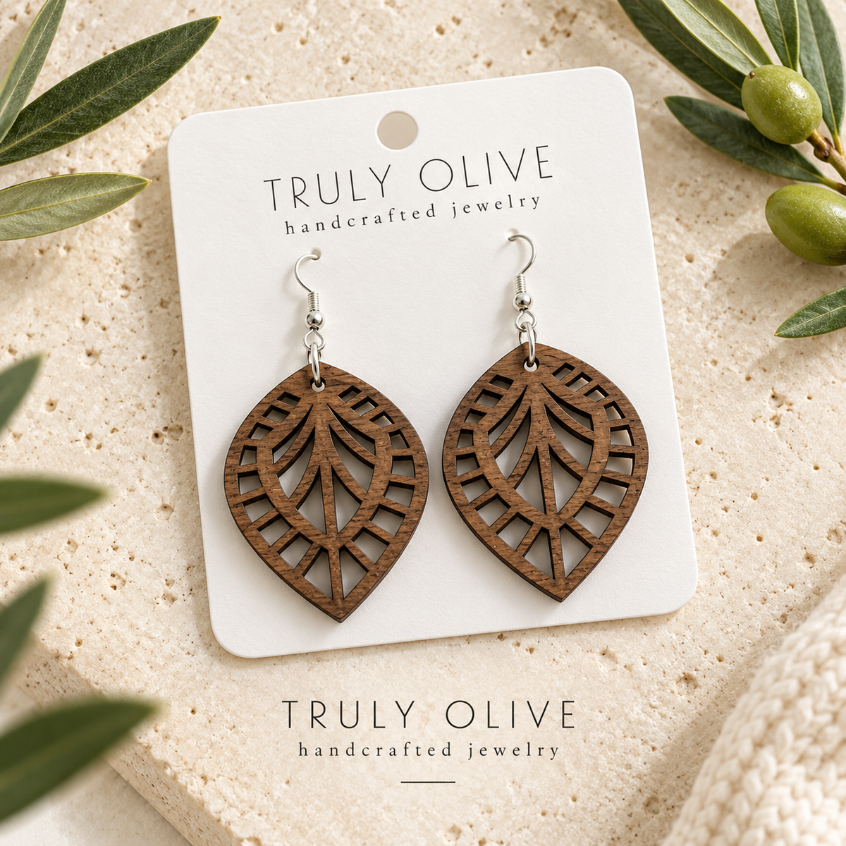 Walnut Leaf Lattice wood earrings arranged flat with Truly Olive branding.