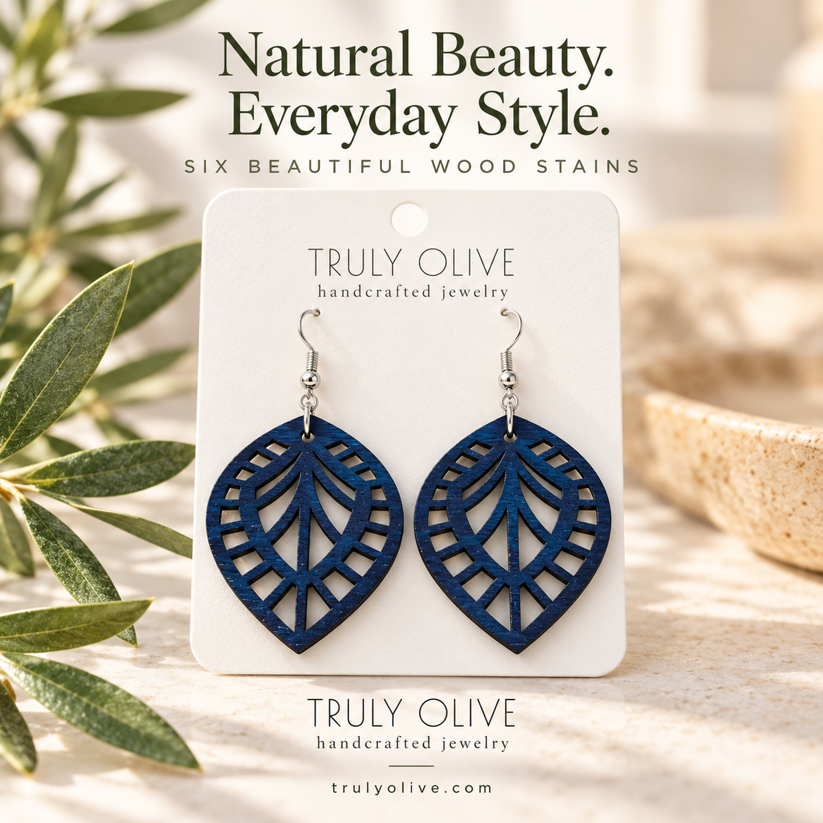Marine Blue Leaf Lattice wood earrings in a styled product image with Truly Olive branding.