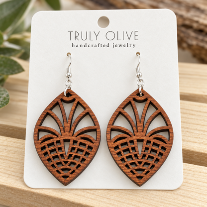 Close view of Sapele Fan Lattice wood earrings showing the wood grain and cutout pattern on a white Truly Olive card.
