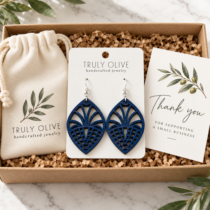 Marine Blue Fan Lattice wood earrings on a white Truly Olive card in a kraft box beside a branded pouch and thank-you note.