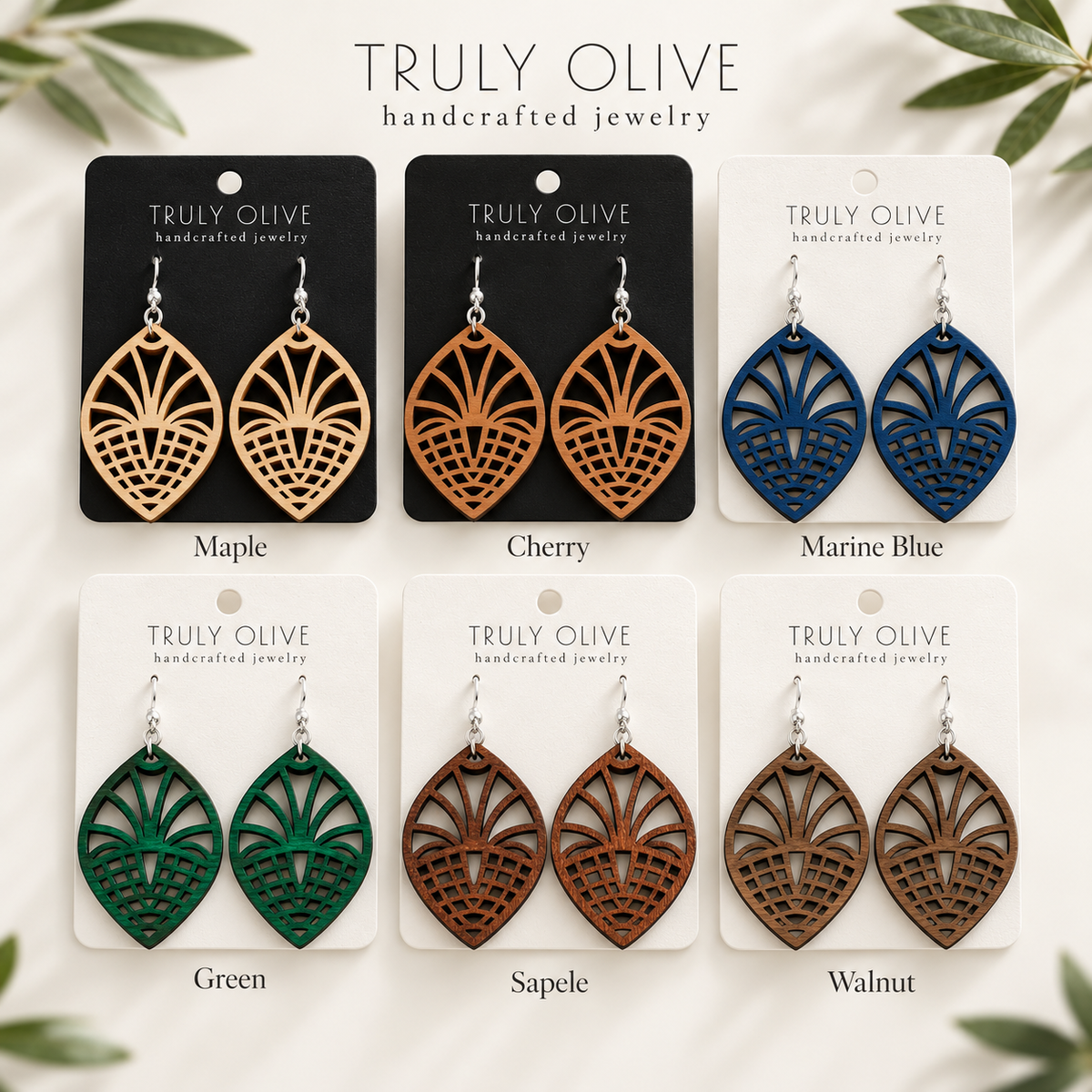Fan Lattice wood earrings shown in Maple, Cherry, Marine Blue, Green, Sapele, and Walnut stains on Truly Olive cards.