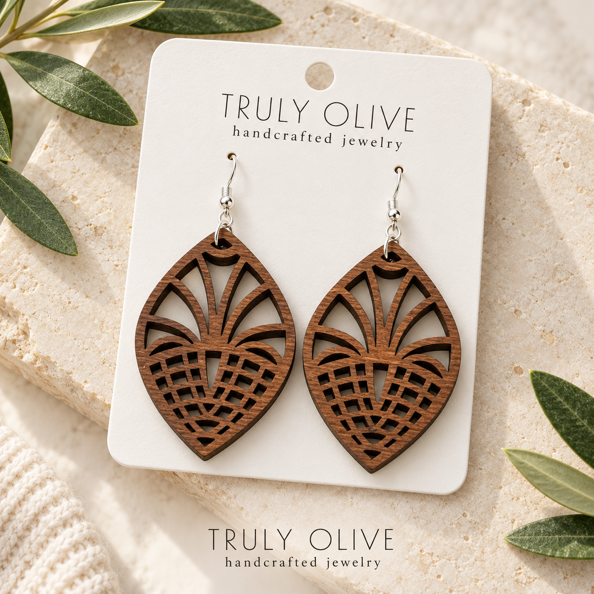 Walnut Fan Lattice wood earrings arranged flat with Truly Olive branding.