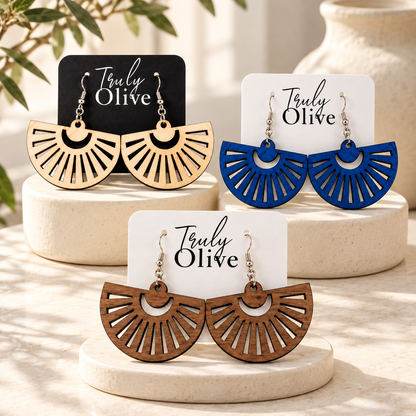 Maple, Marine Blue, and Walnut fan earring pairs on Truly Olive cards and ivory stands.