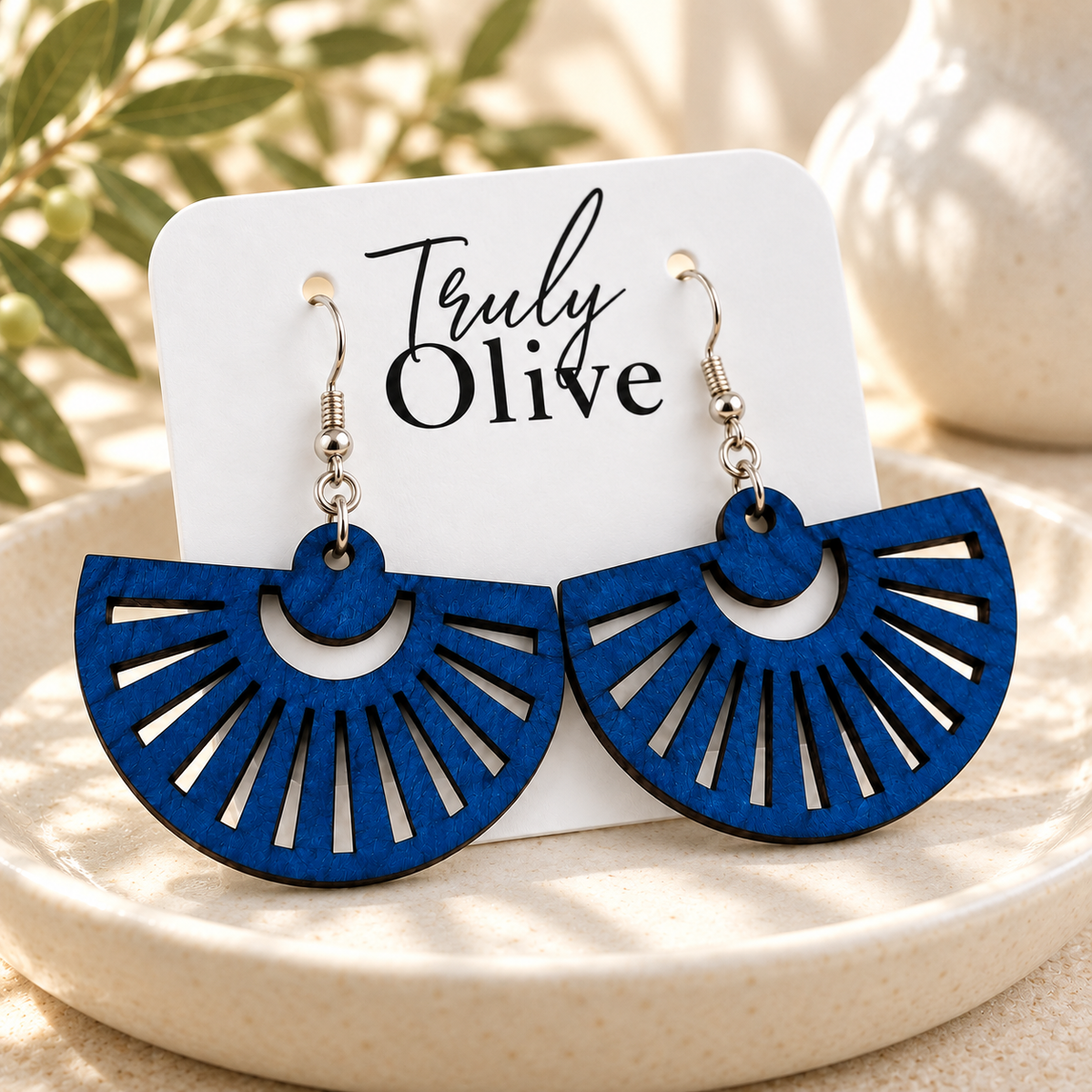 Marine Blue fan earrings presented on a white Truly Olive card in an ivory tray.