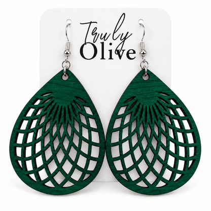 Green wooden teardrop earrings with geometric lattice cutouts on a white Truly Olive card.