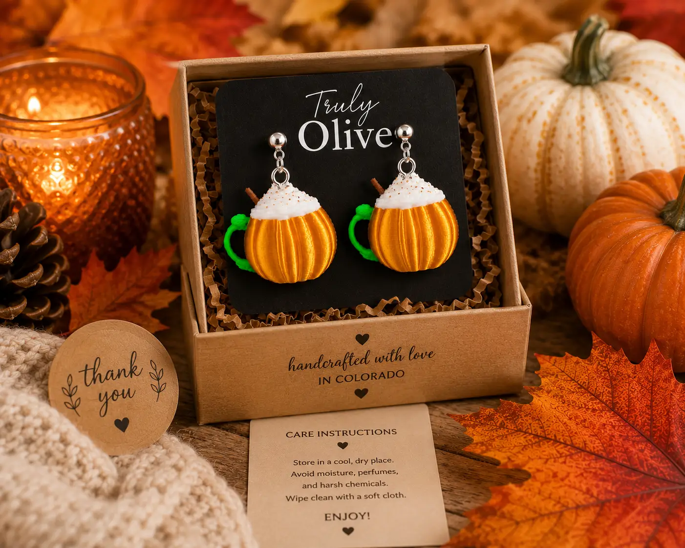 Macro view of handmade pumpkin spice coffee cup earrings showing intricate fall details, lightweight construction, and handcrafted quality by Truly Olive.